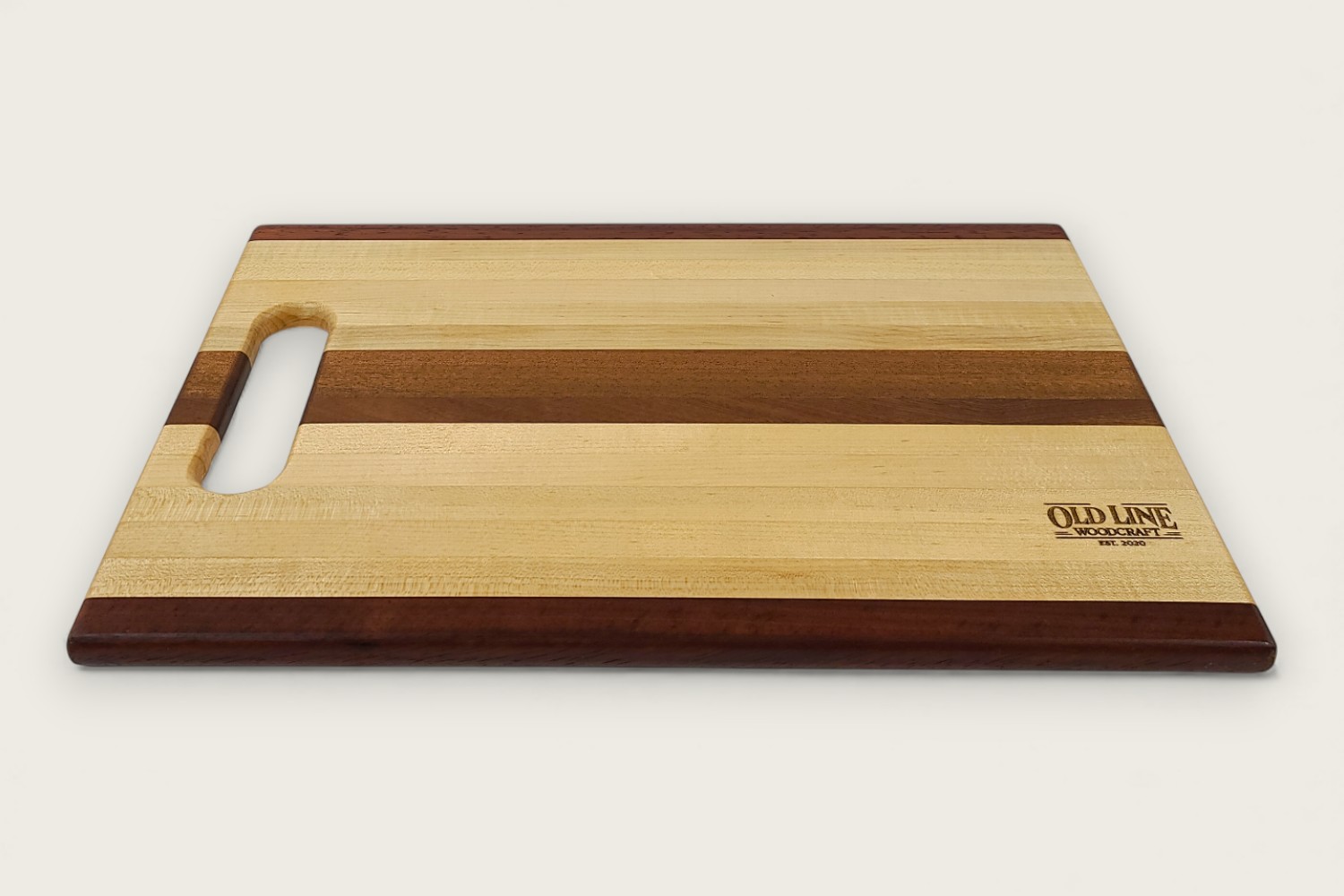 Mahogany-accented maple chef board with light edge grain, horizontal pattern, rectangle shape, and tung oil finish.