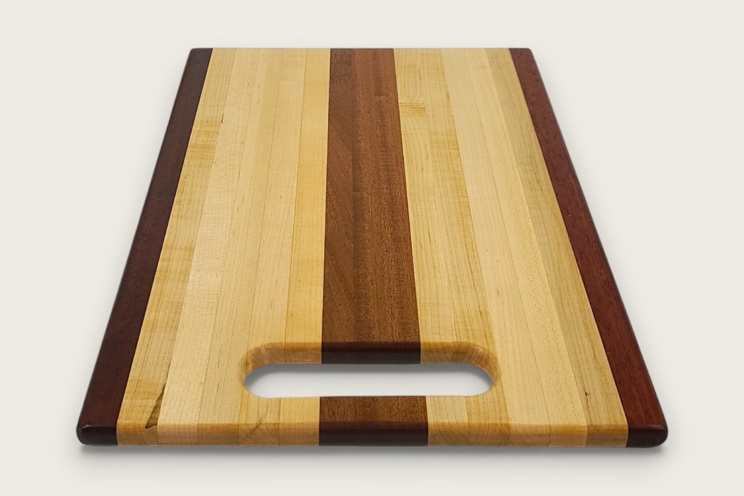 Mahogany-accented maple chef board with light edge grain, horizontal pattern, rectangle shape, and tung oil finish.