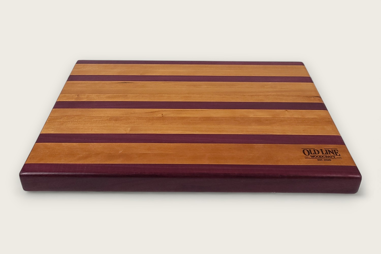 Cherry & Purpleheart Butcher Block (#100) with edge-grain cherry wood, purpleheart accents, and a rectangular shape.