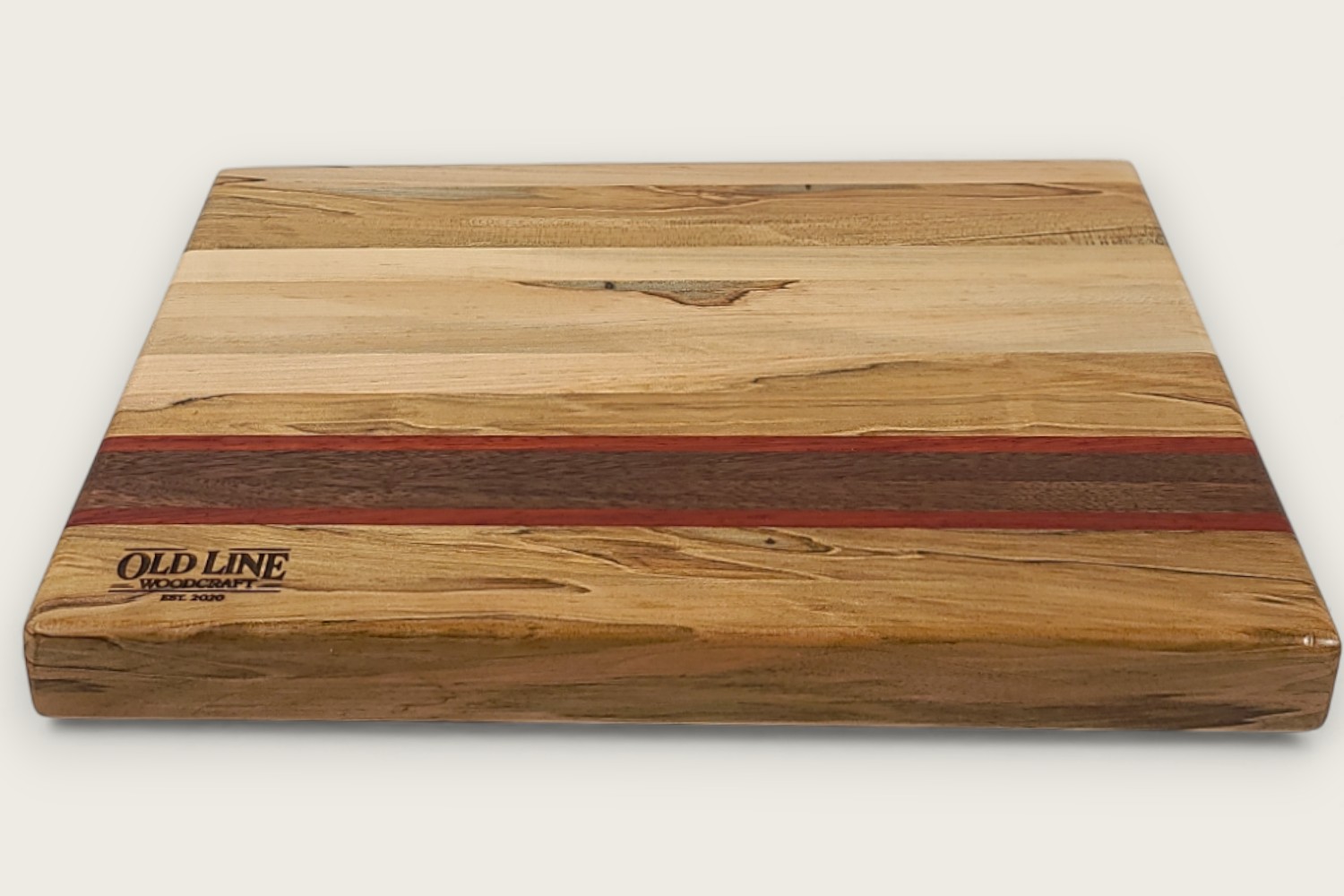 Spaulted Maple Butcher Block Board (#140) with light maple edge grain, walnut and purpleheart accents, and a recessed handle.