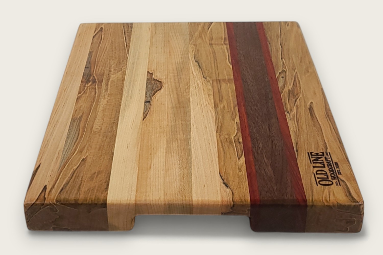 Spaulted Maple Butcher Block Board (#140) with light maple edge grain, walnut and purpleheart accents, and a recessed handle.