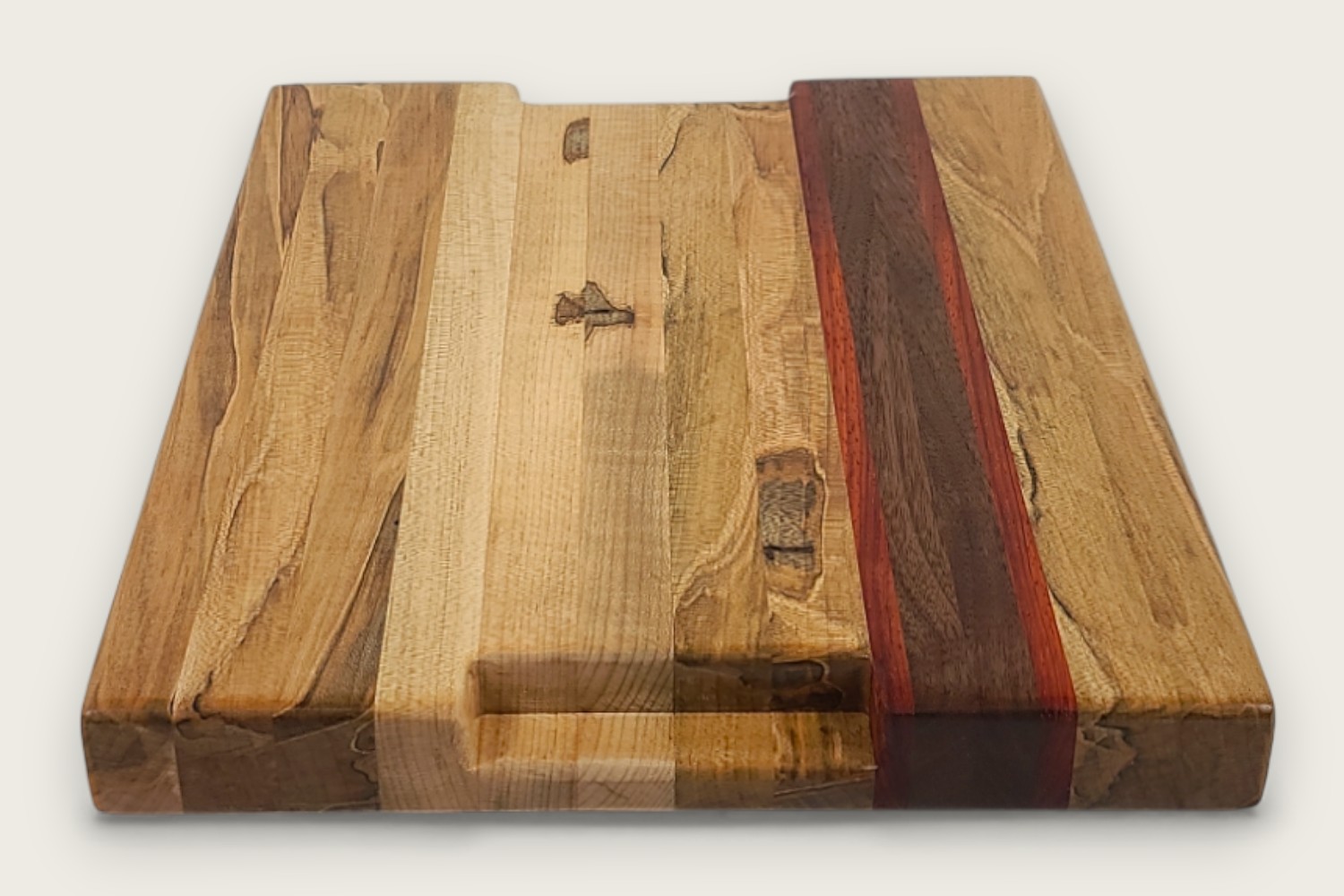 Spaulted Maple Butcher Block Board (#140) with light maple edge grain, walnut and purpleheart accents, and a recessed handle.