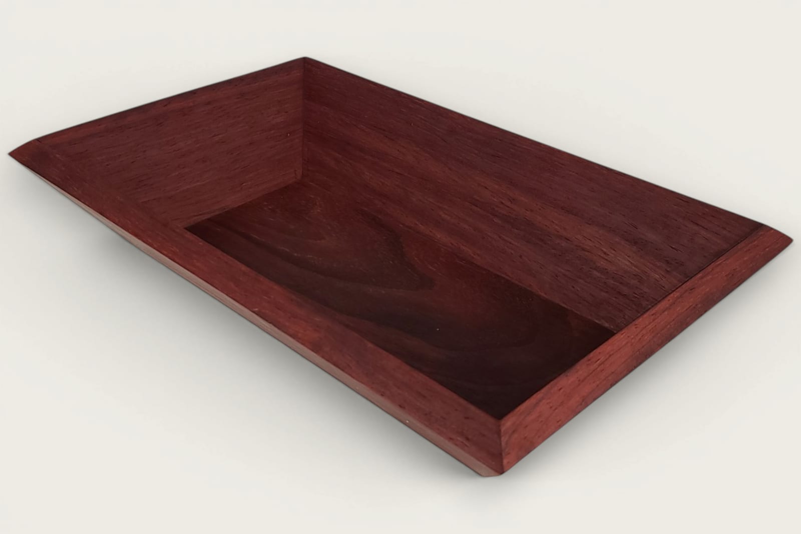 Padauk catch-all bowl with horizontal face grain, rectangular shape, warm reddish tones, and a tung oil finish.