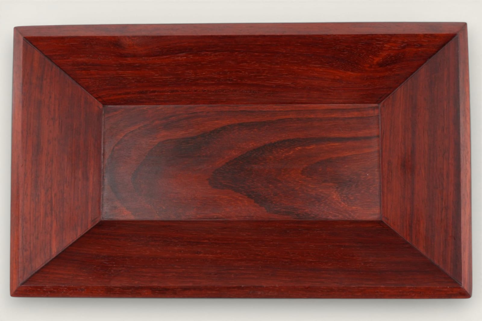Padauk catch-all bowl with horizontal face grain, rectangular shape, warm reddish tones, and a tung oil finish.
