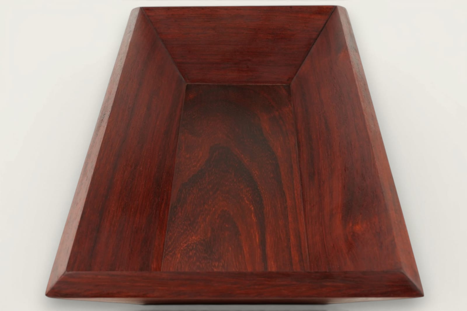Padauk catch-all bowl with horizontal face grain, rectangular shape, warm reddish tones, and a tung oil finish.