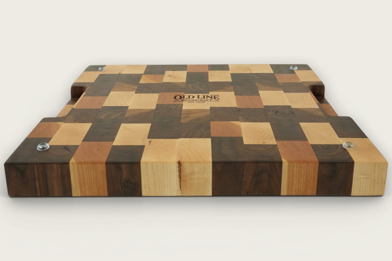 Walnut end-grain Calico chopping board with checker pattern, recessed handles, and rich brown tones.