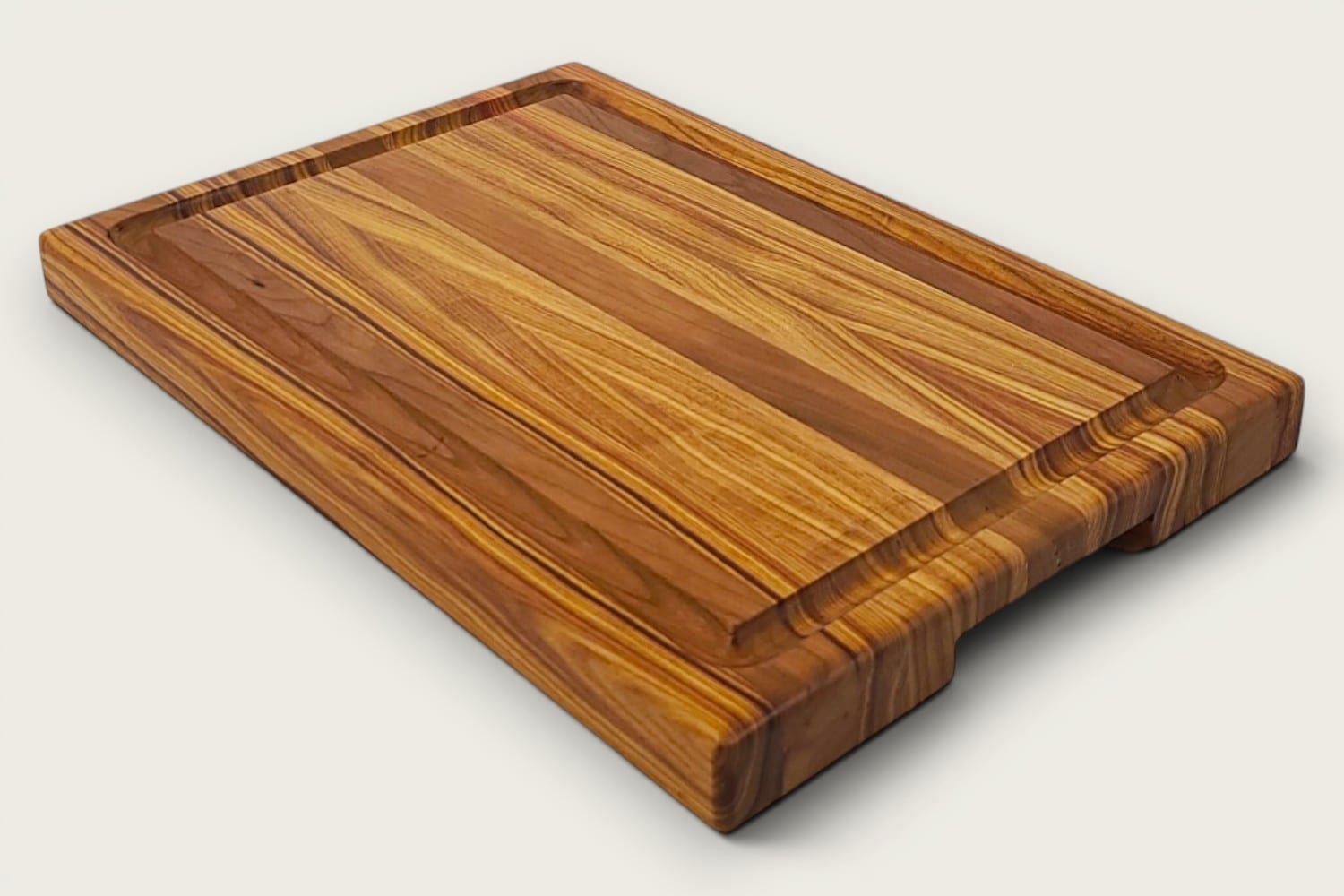 Canary and Cherry Butcher Block Board, edge-grain rectangle in tung oil, warm gold-brown tones, recessed handle.