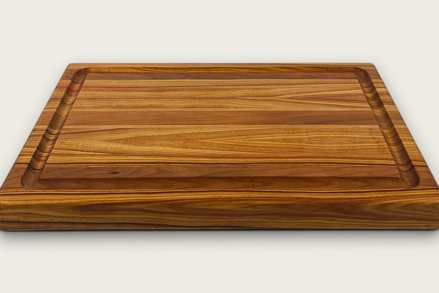 Canary and Cherry Butcher Block Board, edge-grain rectangle in tung oil, warm gold-brown tones, recessed handle.
