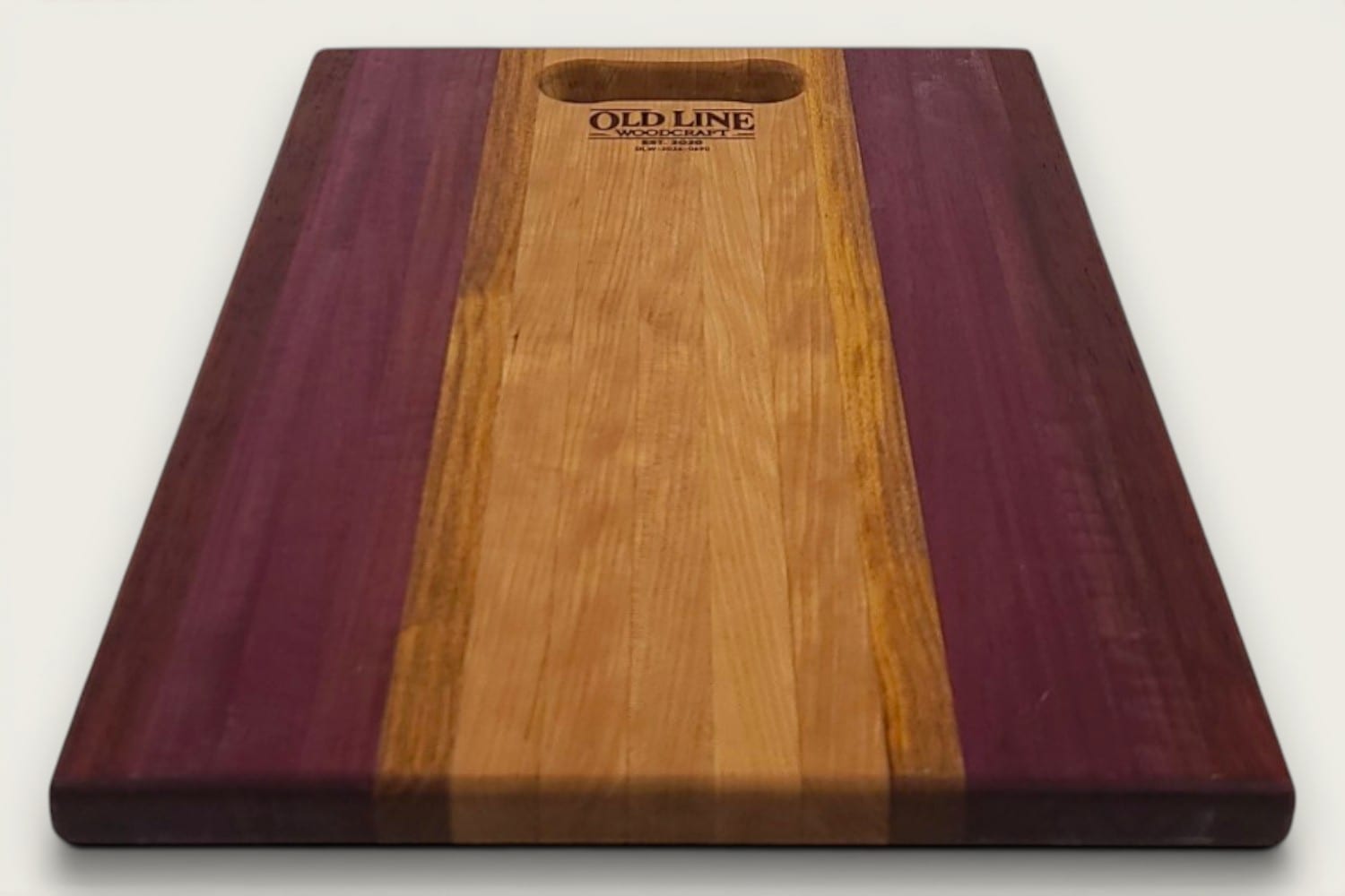 Cherry Canary Purpleheart Padauk Pro Series cutting board, edge-grain rectangle with tung-oil finish and OldLine bone handle