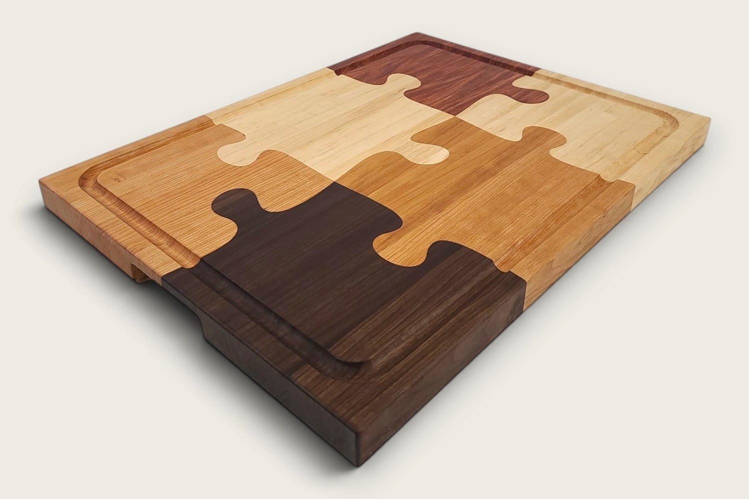 The Pitmaster Butcher Block Puzzle Board, cherry edge grain, tung-oiled rectangle with checker puzzle inlay.