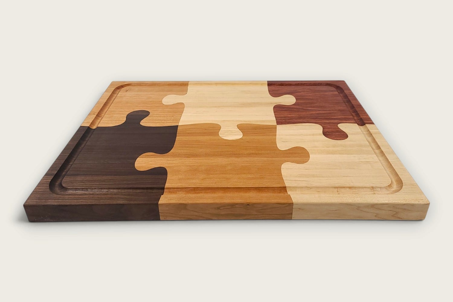 The Pitmaster Butcher Block Puzzle Board, cherry edge grain, tung-oiled rectangle with checker puzzle inlay.